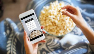 mobile phone taking an Instagram Stories quiz while eating popcorn