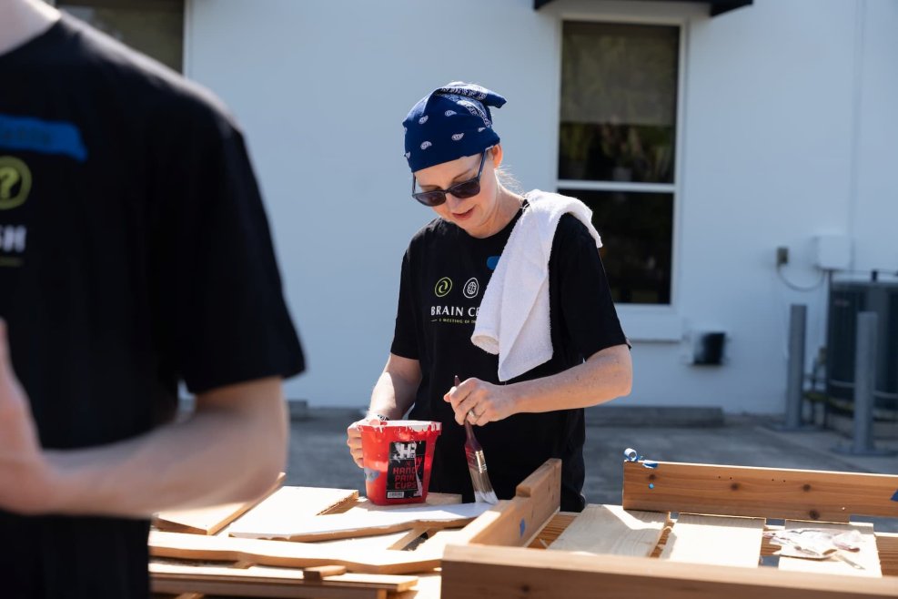 Dolly, a graphic designer at Appleton Creative, painting parts of a children's playhouse for Habitat for Humanity.